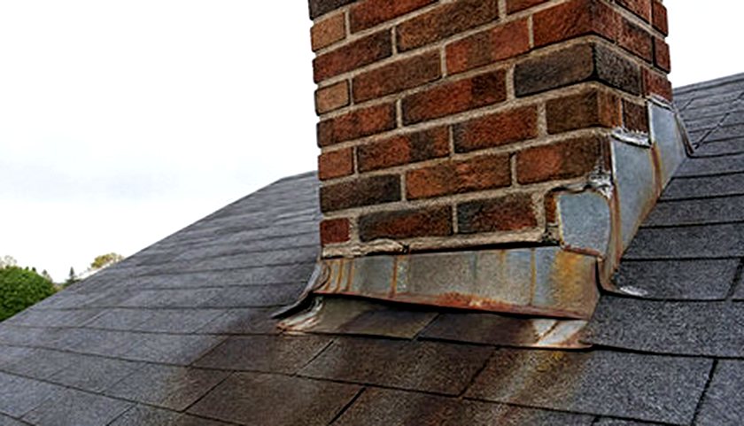 Rust trailing from failing chimney flashing down the roof